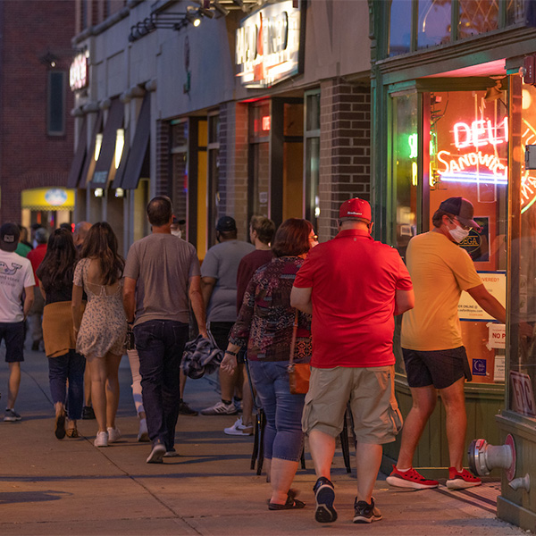people walking down the streets of uptown oxford in the evening