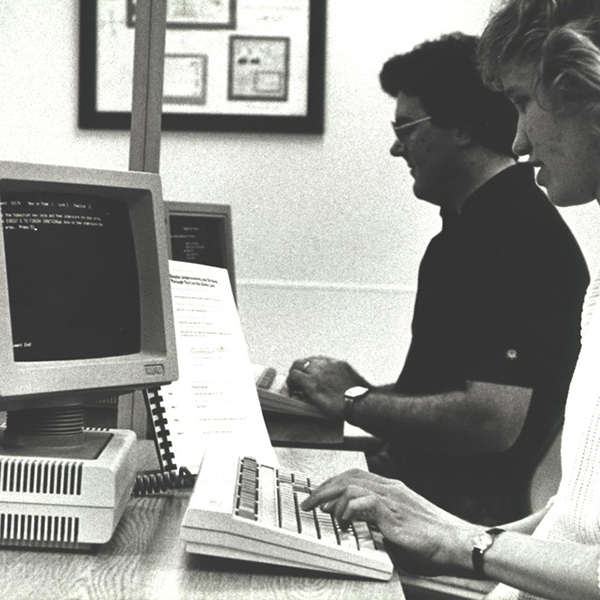 two people working on computers