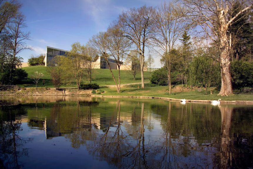 Photograph of the Miami University Art Museum with a lake in the foreground.